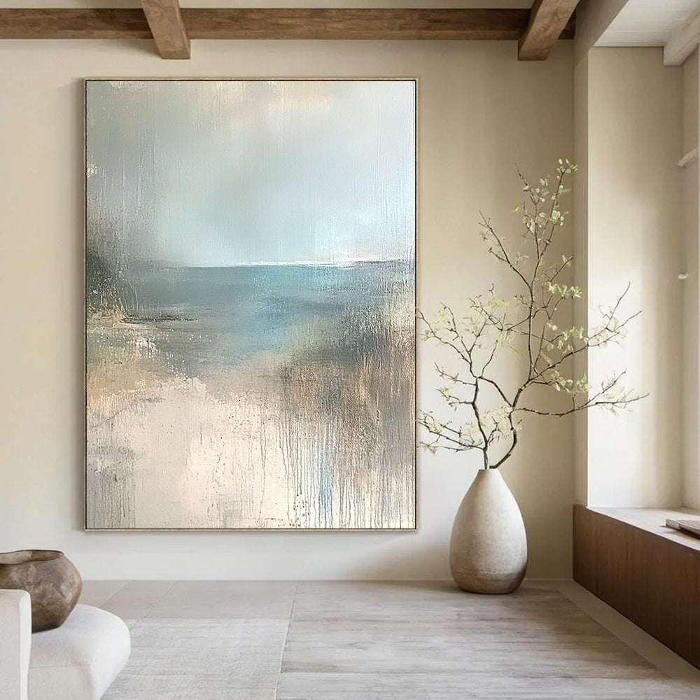 Contemporary hand-painted abstract art featuring a serene empty beach in soft beige, pale blue, and grey tones. Perfect for calming spaces. DLZ0950