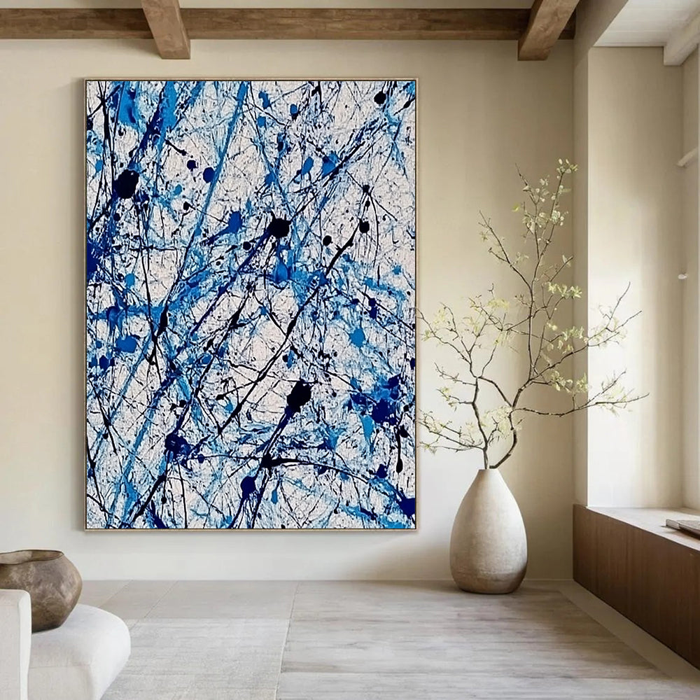 Contemporary abstract painting features vibrant blue and white ink splashes with lace-like patterns creating dynamic movement and evoking joy. DLZ1410