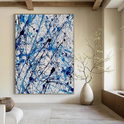 Contemporary abstract painting features vibrant blue and white ink splashes with lace-like patterns creating dynamic movement and evoking joy. DLZ1410