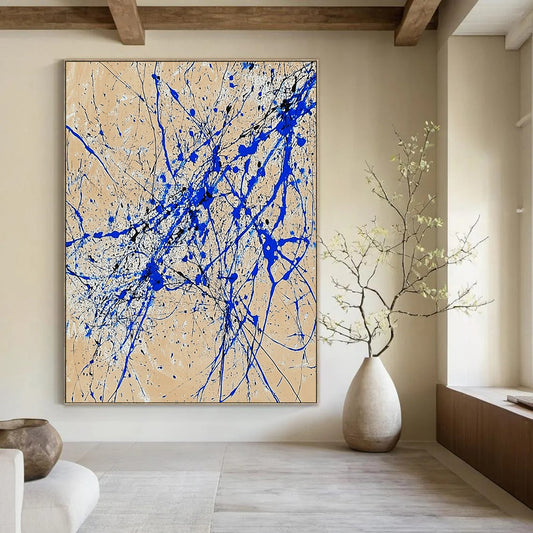 Contemporary abstract art features dynamic blue and white lines on beige paper in a vertical splatter style reminiscent of Jackson Pollock. DLZ0977