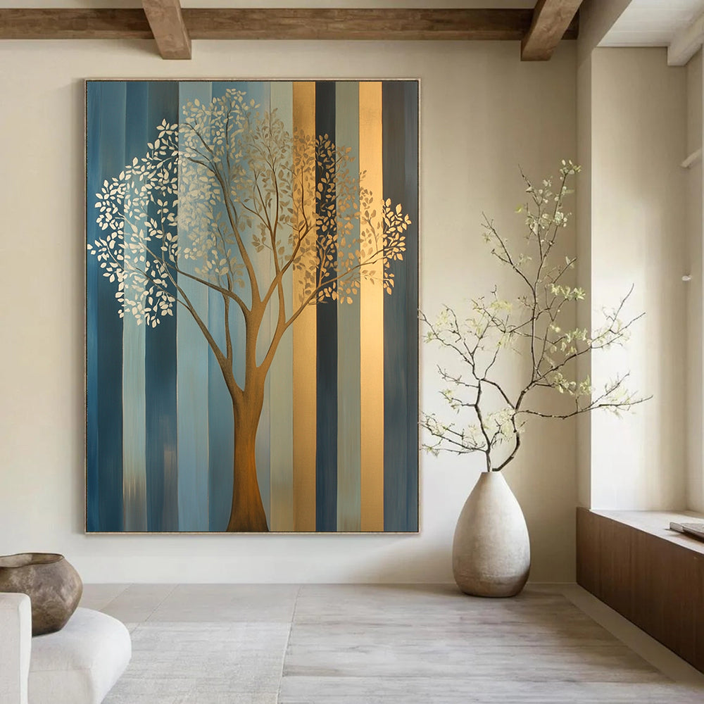 Contemporary hand-painted abstract artwork features an elegant tree in soft gold and silver tones against muted teal and geometric blue-gray stripes. DLZ1403