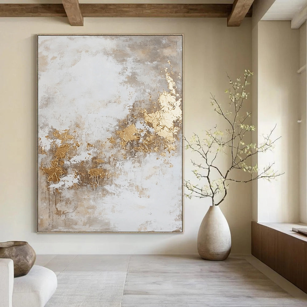 Contemporary hand-painted abstract artwork featuring dynamic paint splatters and luxurious gold foil accents against a backdrop of beige and grey hues. DLZ0534