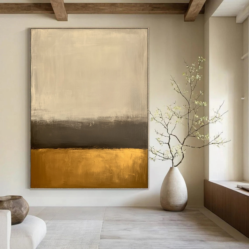 Large contemporary abstract painting featuring an off-white background and gold bottom with minimalist earth tones and low contrast for a serene aesthetic. DLZ1013