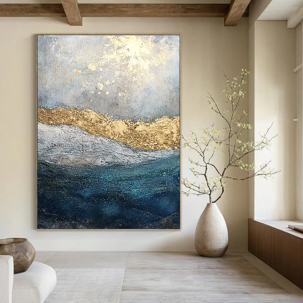 Contemporary abstract painting features textured layers of paint and glitter with a soft gray sky and deep blue sea enhanced by golden foil accents. DLZ1078