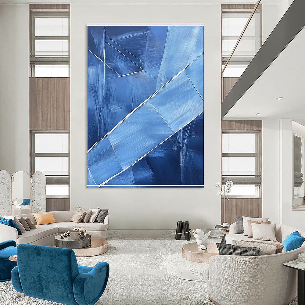 Contemporary hand-painted abstract art featuring blue shapes overlapping with soft edges and textured brushstrokes accented by a large white frame on the canvas. DLZ0367