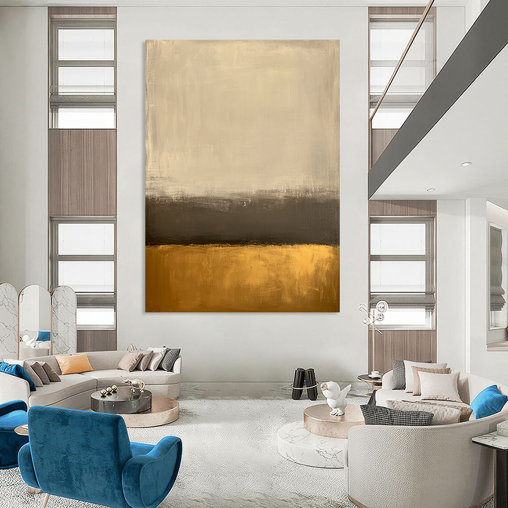 Large contemporary abstract painting featuring an off-white background and gold bottom with minimalist earth tones and low contrast for a serene aesthetic. DLZ1013