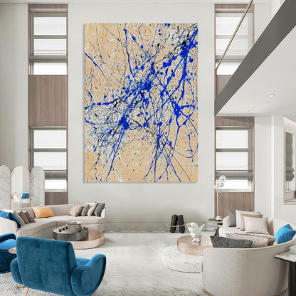 Contemporary abstract art features dynamic blue and white lines on beige paper in a vertical splatter style reminiscent of Jackson Pollock. DLZ0977