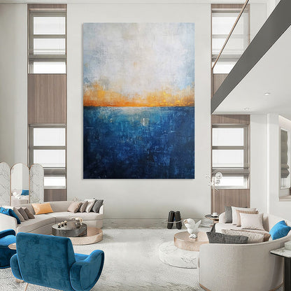 Contemporary abstract artwork featuring a deep blue ocean textured canvas with misty horizon neutral colors and elegant gold highlights. DLZ0468