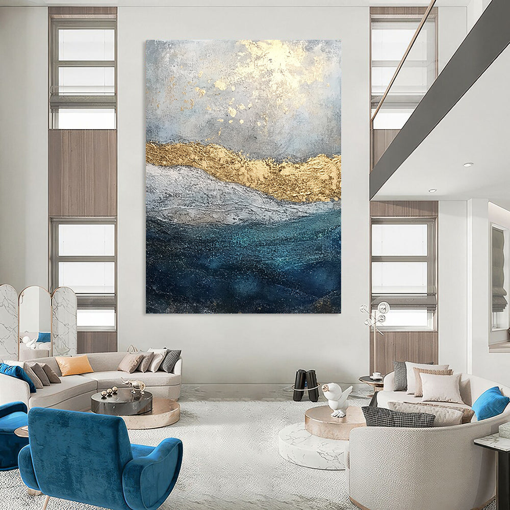Contemporary abstract painting features textured layers of paint and glitter with a soft gray sky and deep blue sea enhanced by golden foil accents. DLZ1078