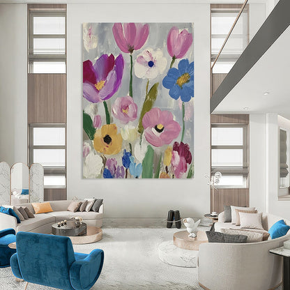 Large contemporary abstract painting featuring vibrant daisies and tulips in pink purple blue green and yellow against a soft gray backdrop with visible brush strokes. DLZ1262