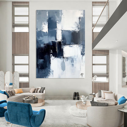 Large contemporary abstract painting featuring dark blue and white brushstrokes on a light gray background evoking calmness and simplicity. DLZ0351