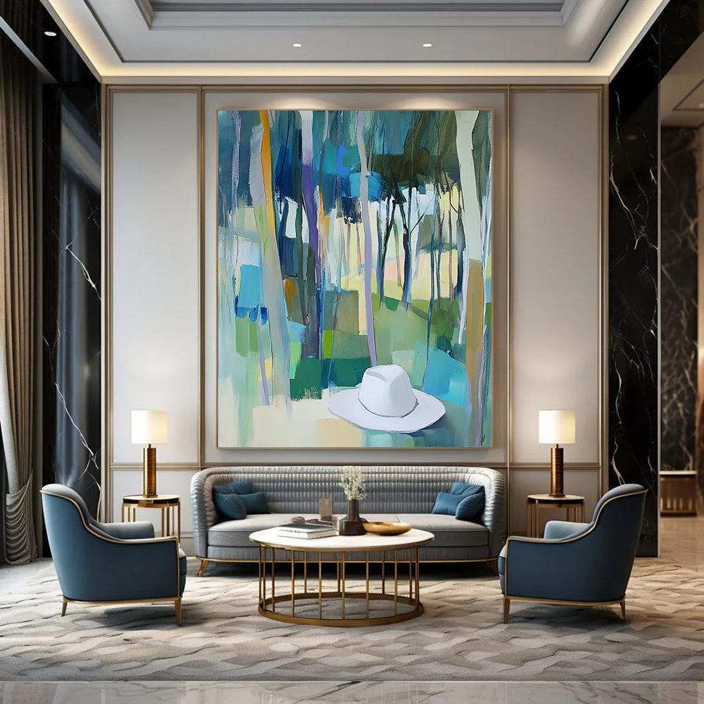 Contemporary abstract painting featuring trees in vibrant blue, green, and yellow hues with a white hat resting on the ground. DLZ0897