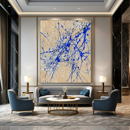 Contemporary abstract art features dynamic blue and white lines on beige paper in a vertical splatter style reminiscent of Jackson Pollock. DLZ0977