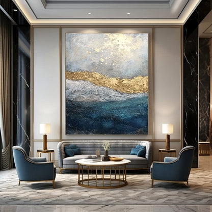 Contemporary abstract painting features textured layers of paint and glitter with a soft gray sky and deep blue sea enhanced by golden foil accents. DLZ1078