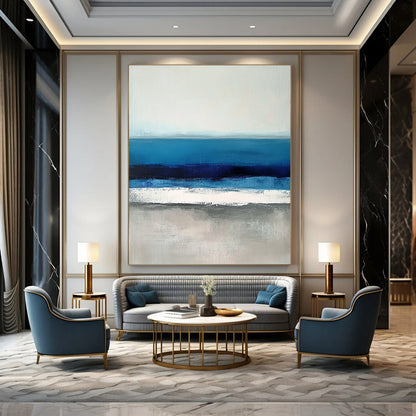 Large contemporary abstract painting featuring soft blues and grays capturing serene sea waves with a hint of deep blue for added depth. DLZ1359