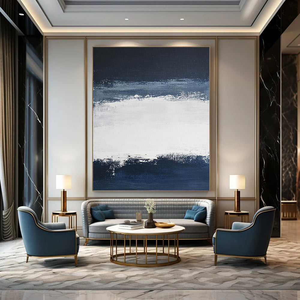 Large contemporary abstract painting featuring broad brush strokes in white and navy blue creating a tranquil atmosphere with a serene dark sky and soft gray clouds. DLZ0546