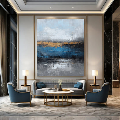 Contemporary large hand-painted abstract artwork featuring blue and gray textures with gold leaf accents on canvas for a striking wall display. DLZ0346