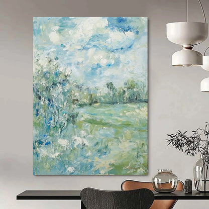 Contemporary hand-painted abstract art featuring soft clouds over serene trees and grass with a calming color palette of blue green and beige. DLZ1473
