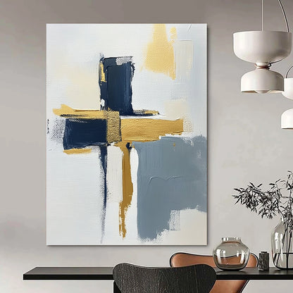 Contemporary hand-painted abstract art featuring a minimalist cross design on a textured canvas with gold highlights navy blue and gray accents. DLZ0592
