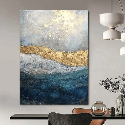 Contemporary abstract painting features textured layers of paint and glitter with a soft gray sky and deep blue sea enhanced by golden foil accents. DLZ1078
