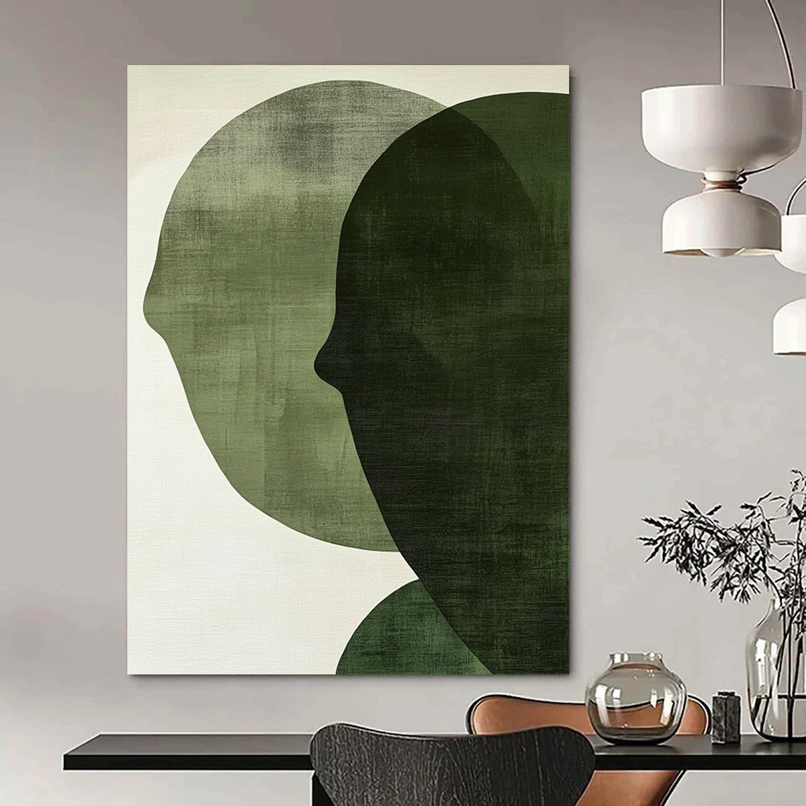 Contemporary abstract art features large forest green shapes on an off-white textured background, creating faces that symbolize connection and balance. DLZ1364