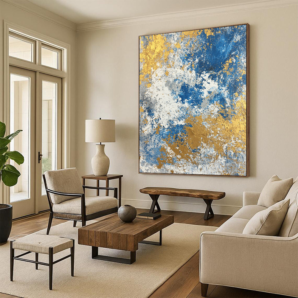 Large contemporary abstract painting featuring a textured blend of blue gold beige white and silver colors. Perfect for modern decor. DLZ0339