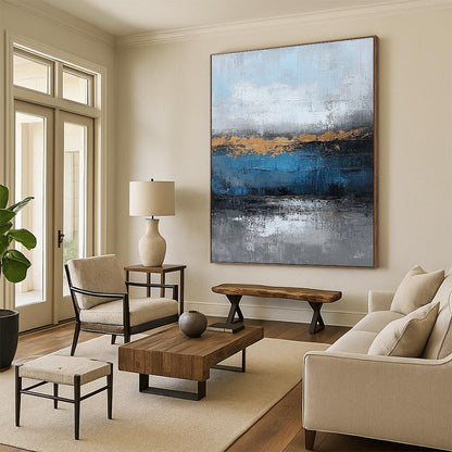Contemporary large hand-painted abstract artwork featuring blue and gray textures with gold leaf accents on canvas for a striking wall display. DLZ0346