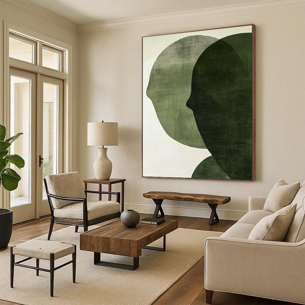 Contemporary abstract art features large forest green shapes on an off-white textured background, creating faces that symbolize connection and balance. DLZ1364