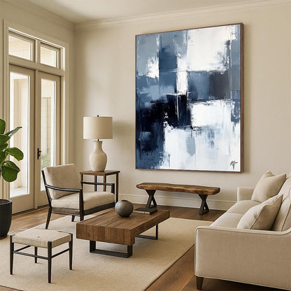 Large contemporary abstract painting featuring dark blue and white brushstrokes on a light gray background evoking calmness and simplicity. DLZ0351