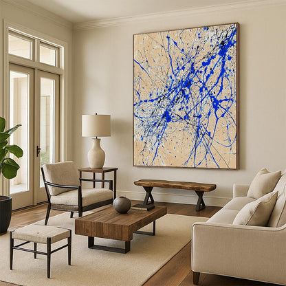 Contemporary abstract art features dynamic blue and white lines on beige paper in a vertical splatter style reminiscent of Jackson Pollock. DLZ0977