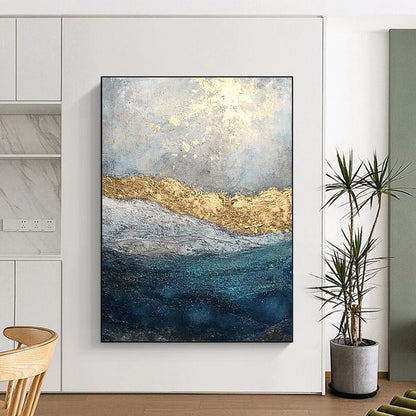 Contemporary abstract painting features textured layers of paint and glitter with a soft gray sky and deep blue sea enhanced by golden foil accents. DLZ1078