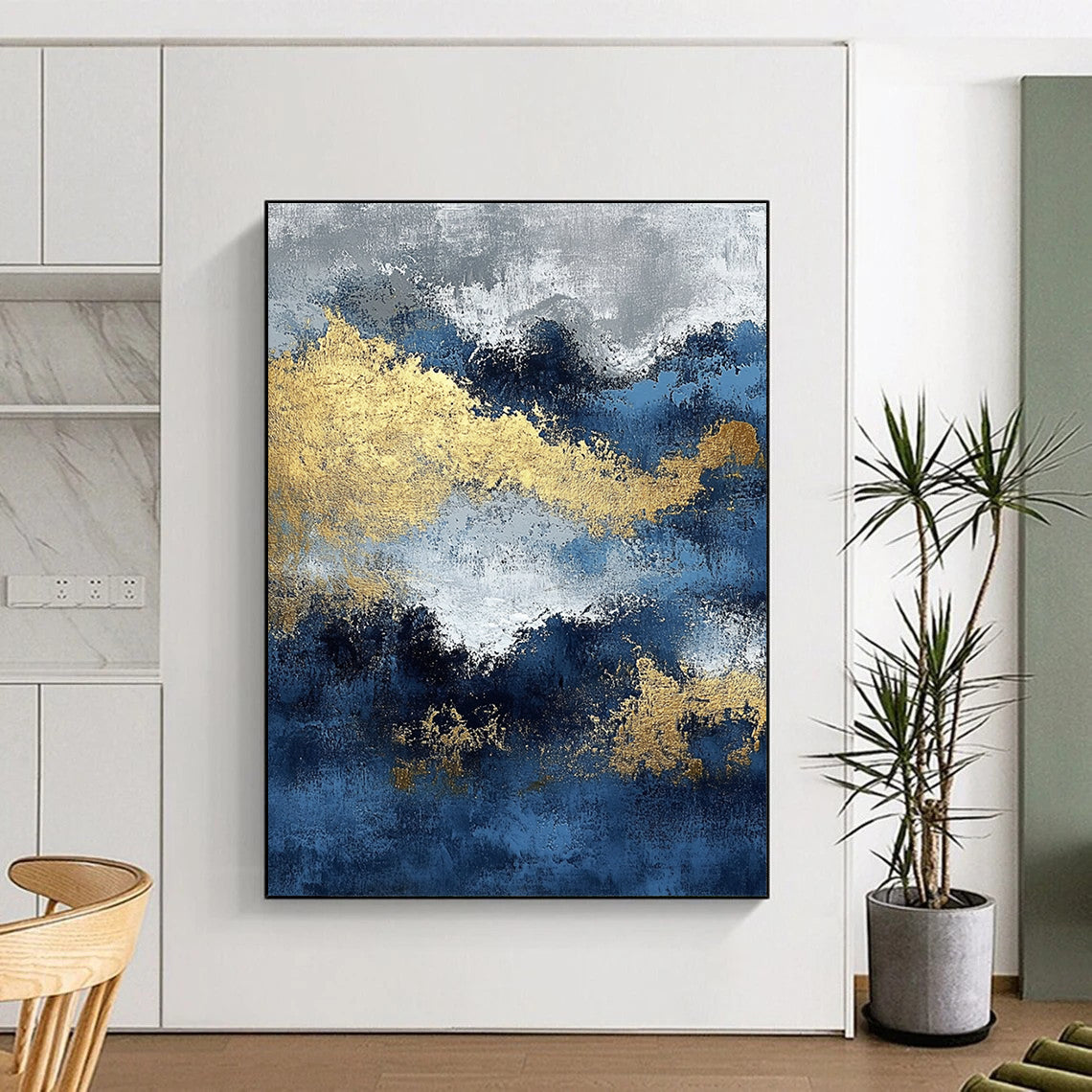 Contemporary abstract painting featuring blue and gold textures with ocean waves and dark silver clouds creating depth and mystery. DLZ0341