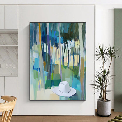 Contemporary abstract painting featuring trees in vibrant blue, green, and yellow hues with a white hat resting on the ground. DLZ0897