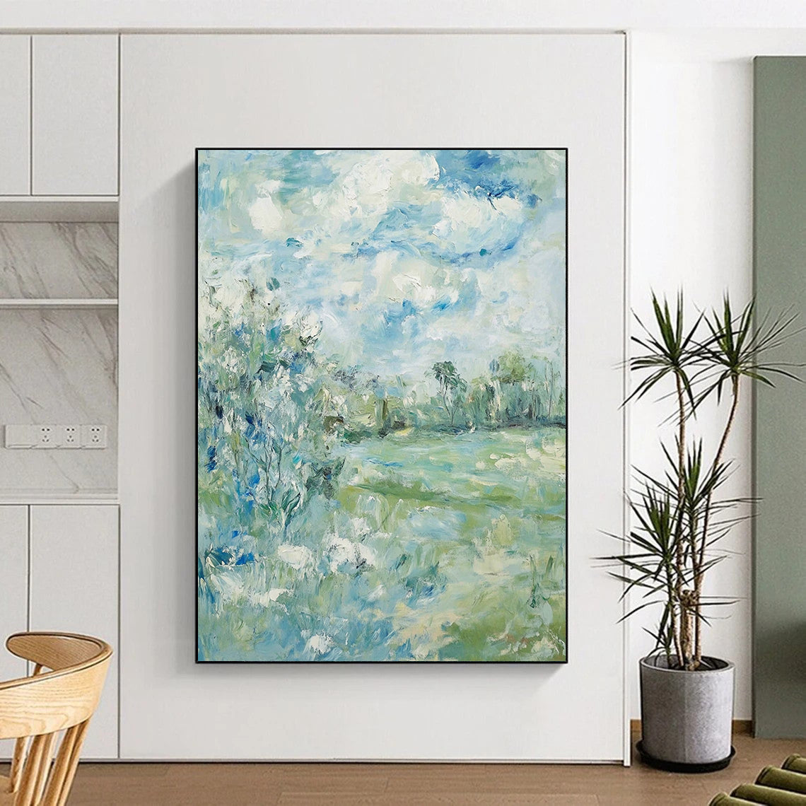 Contemporary hand-painted abstract art featuring soft clouds over serene trees and grass with a calming color palette of blue green and beige. DLZ1473