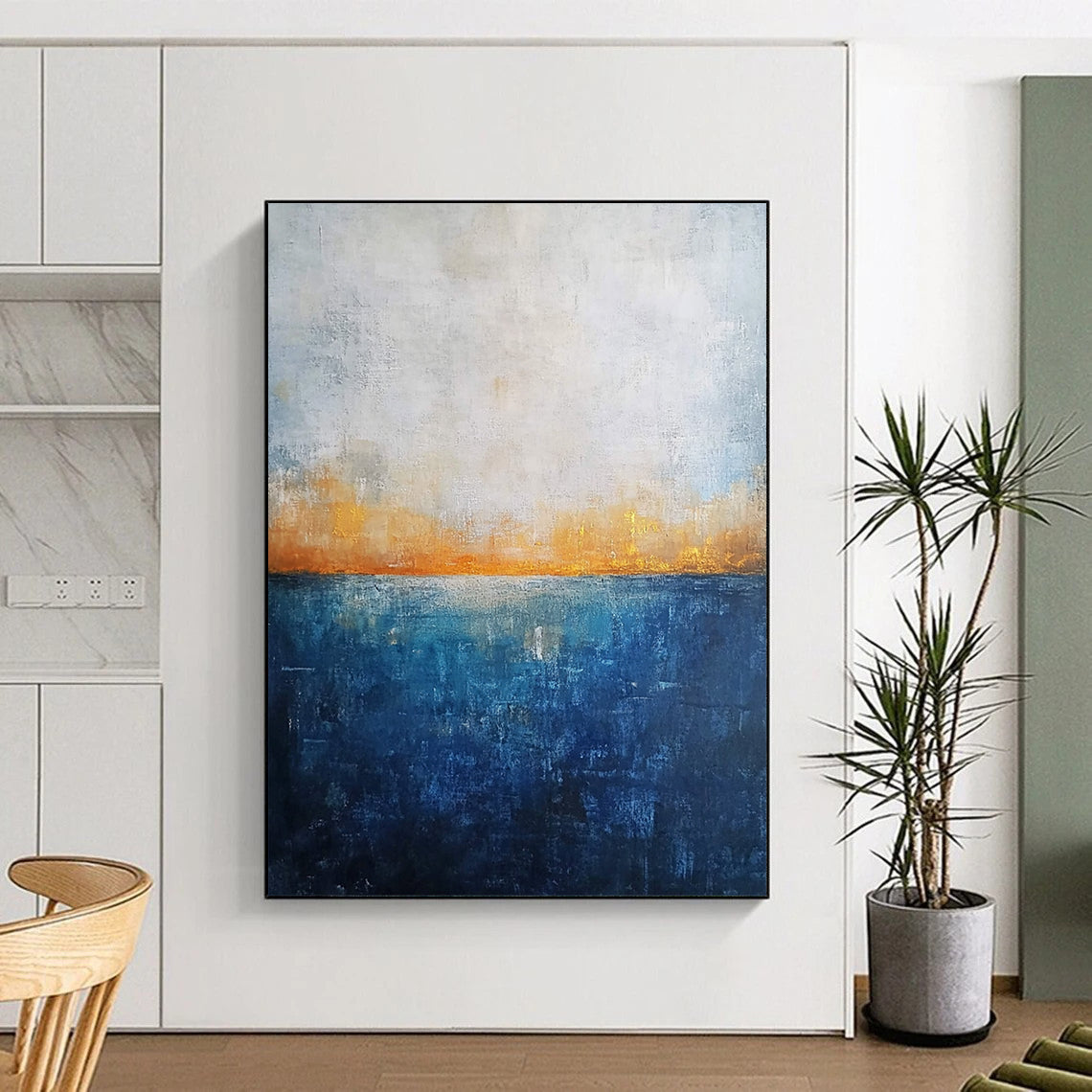 Contemporary abstract artwork featuring a deep blue ocean textured canvas with misty horizon neutral colors and elegant gold highlights. DLZ0468