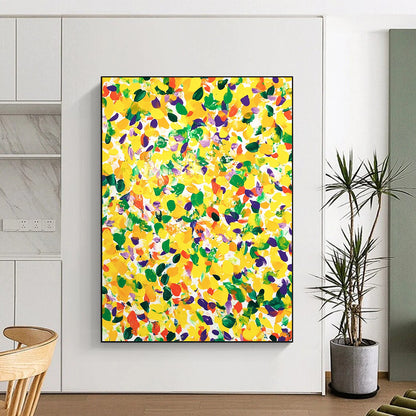 Vibrant contemporary abstract art featuring a large yellow canvas splashed with joyful green and purple spots against a clean white background. DLZ1297