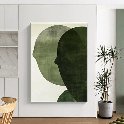 Contemporary abstract art features large forest green shapes on an off-white textured background, creating faces that symbolize connection and balance. DLZ1364